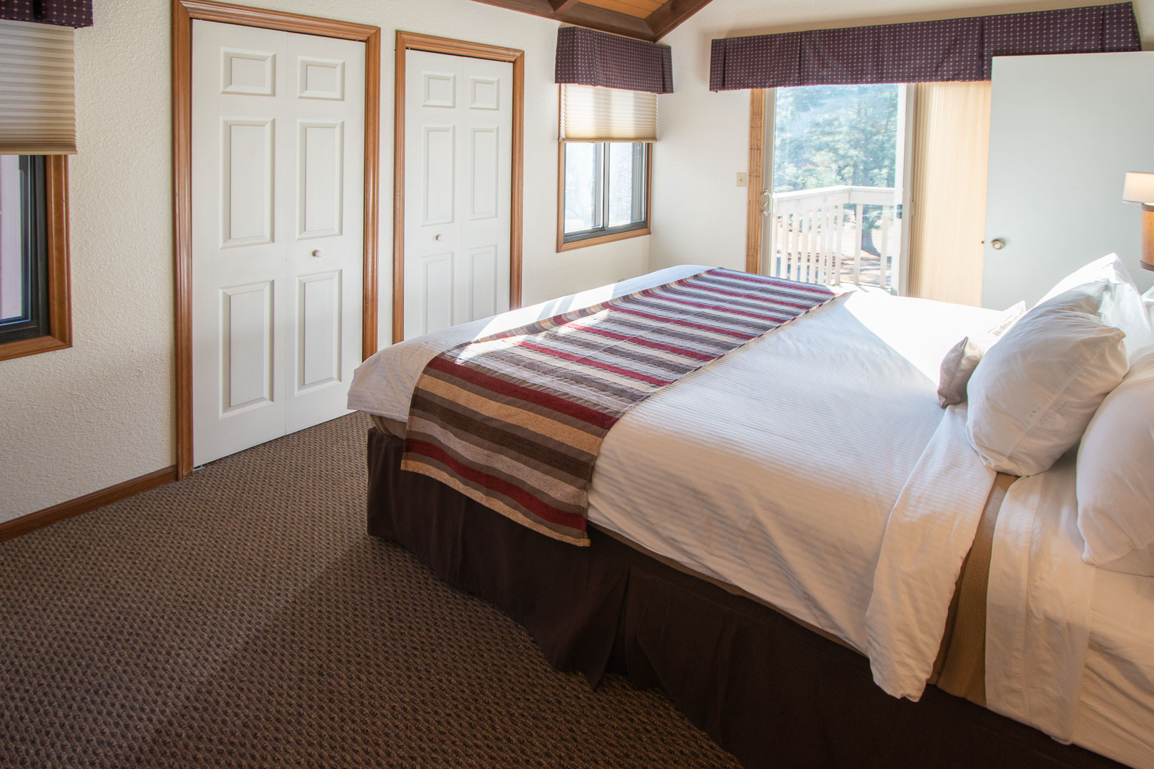 A cozy master bedroom with a view at VRI's Mountain Loft Resort in North Carolina.